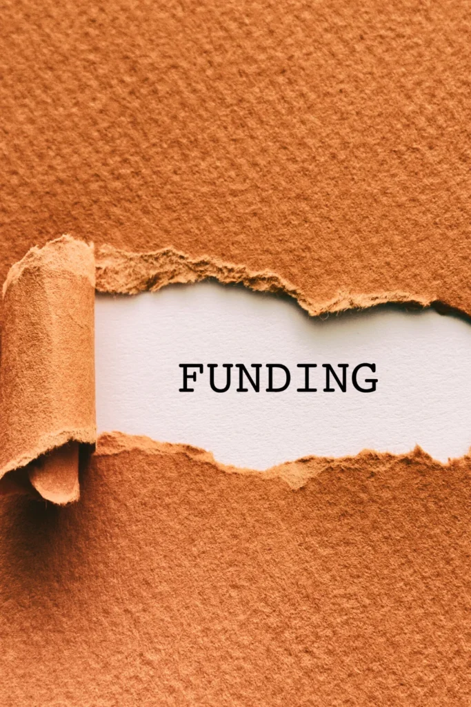 a rip in paper that says funding