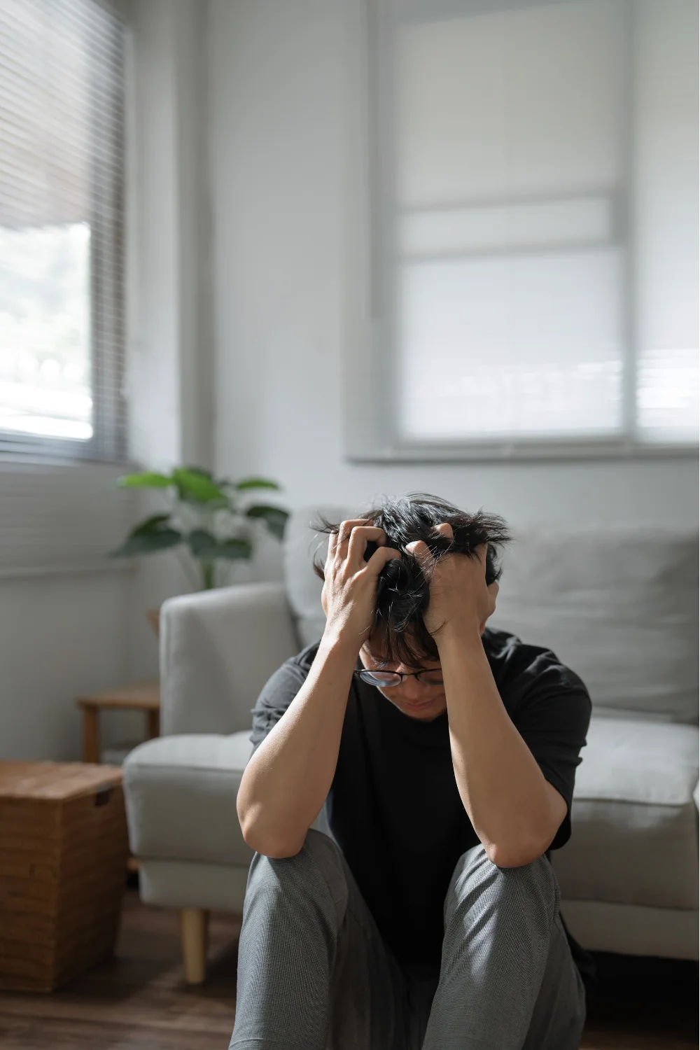 man with hands on head