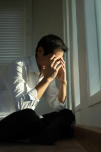 man with hands on head